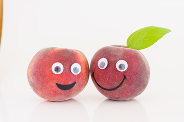 Fruit with a smile and eyes. Smiling peach