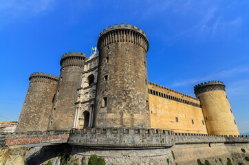Fototapeta na wymiar Castel Nuovo Medieval fortress with 5 towers and a Renaissance triumphal arch often called Maschio Angioino one of the main architectural landmarks of the city.