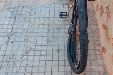A dark punctured and damaged bicycle wheel