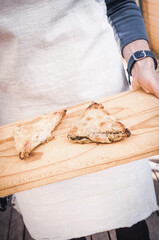 pies being served on a bread board