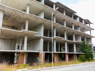 Obraz premium Sky above the multi-storey building, new home for many families and new life, the construction of multi-storey building as symbol of hope for better life