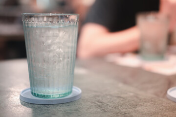 Close up of ice in drinking glass on dinner table
