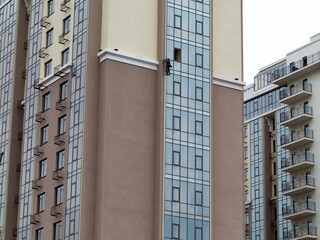 Odessa, Ukraine - February 25, 2016: Workers cleaning windows service on high rise building