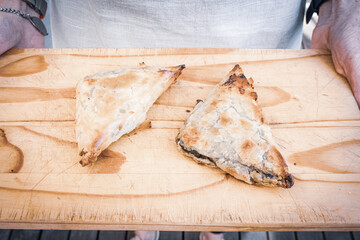 pies being served on a bread board