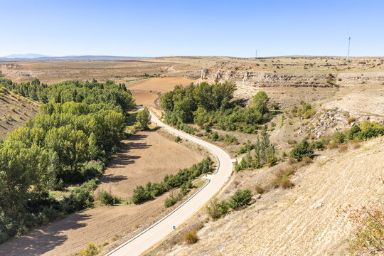 paved road along the Escalote river and the plateau close to Rello village, province of Soria, Castile and Leon, Spain	