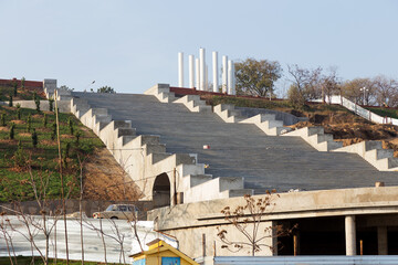 Construction of concrete staircase on city embankment. Staircase is upward.