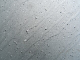 Traces of gray paint on a gray metal surface.