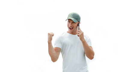 Good news from friend. Smiling young man pointing at smartphone. Yes. Mobile. White background. 