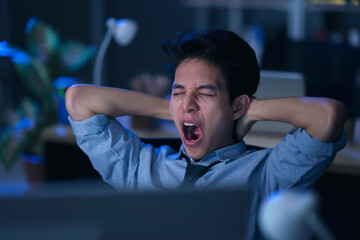 Businessman in the office at night working late