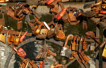 Rusty locks on the railings of a bridge