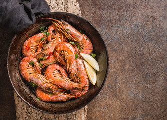 Shrimps delicious dish on dark background copy space.