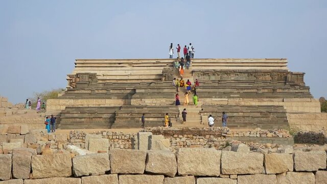 Hampi, Karnataka, India - January 21st, 2019: Tourists on stairs of the ancient temple.