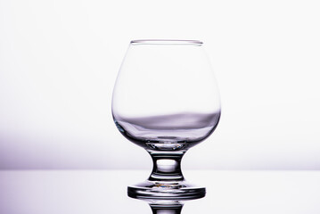 one transparent glass cognac glass isolated on a white background 