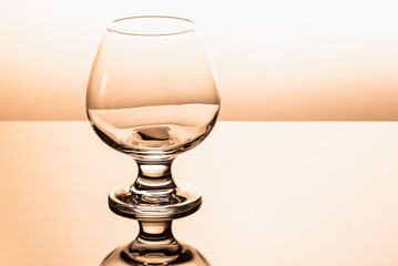 yellow hue, color, one clear glass cognac glass isolated on a white background, there is an...