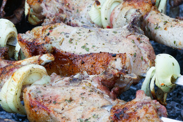 Grilled kebab cooking on metal skewer. Roasted meat cooked at barbecue. BBQ fresh beef meat chop slices. Traditional eastern dish, shish kebab. Grill on charcoal and flame, picnic, street food