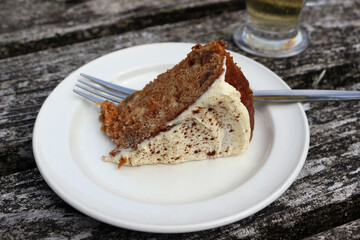 A piece of carrot cake on a white plate 