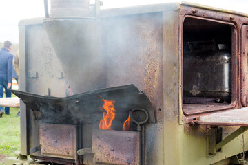 Steam of cooking food. Fragment of a military field kitchen close-up. Military field kitchen during war gave soldiers warm meal.