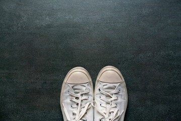 woman selfie of feet with shoes on the black floor background, lifestyle and travel concept