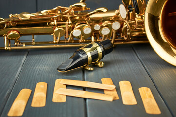 saxophone mouthpiece with metal clamp and gold adjustment hardware