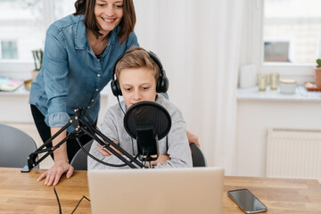 Mother and son recording a podcast together