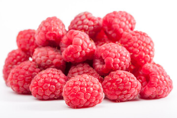 Lot of organic raspberries on white background. Selective focus
