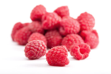 Lot of organic raspberries on white background. Selective focus