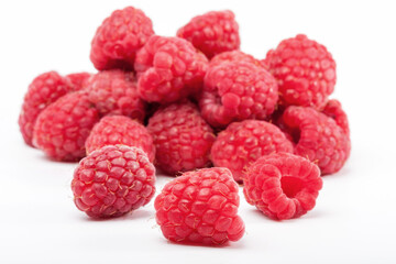 Lot of organic raspberries on white background. Selective focus