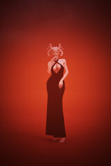 Devil Woman In a Black Pant Suit Standing Red Orange Background 3d Illustration 