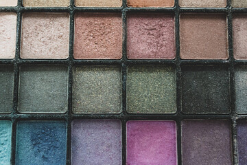 Close up palette with multi colored eye shadow. Makeup nude color, blue, turquoise and pink