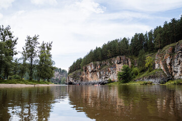 Fototapeta premium rock mass, river flows at the foot of the rocky mountains, white stone rocks, nature of Russia, southern Urals, Yuryuzan river, travel idea