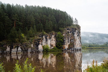 Fototapeta na wymiar rock mass, river flows at the foot of the rocky mountains, white stone rocks, nature of Russia, southern Urals, Yuryuzan river, travel idea