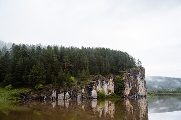 Fototapeta na wymiar rock mass, river flows at the foot of the rocky mountains, white stone rocks, nature of Russia, southern Urals, Yuryuzan river, travel idea