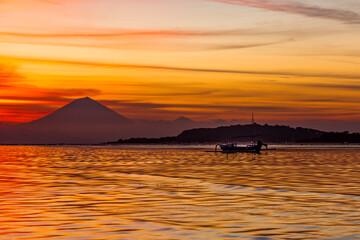 Traditional boat silhouetted against the sunset