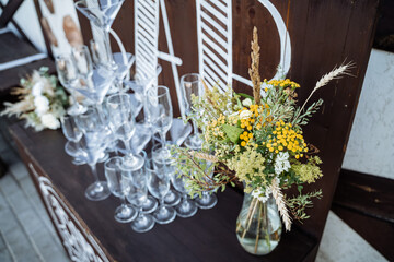 Serving a festive table, placing plates on the table, a Banquet table with a white tablecloth, preparing the dining table for the holiday, Cutlery is arranged according to etiquette. 