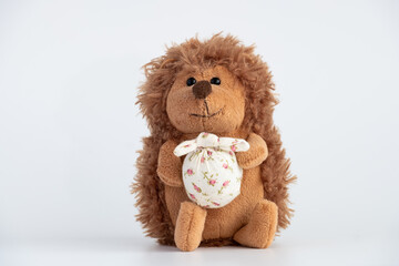 Soft toy hedgehog on a white background