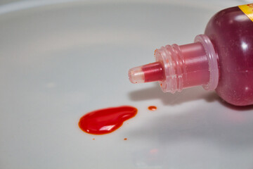 red food dye on white plate