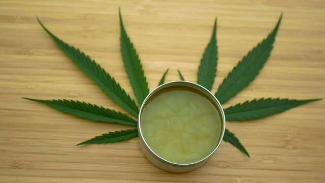 Lubricates cream cannabis hemp ointment on hand medicinal cannabidiol CBD leag leaves, body massage relaxed effect, relieves applying pain scrub, liniment relax, antibacterial soothing, THC marijuana