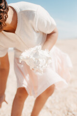 Curly young toddler girl with seashell