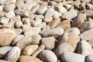 lot of stones close-up on beach, pebbles as textured background