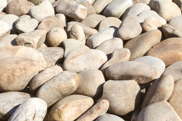 lot of stones close-up on beach, pebbles as textured background
