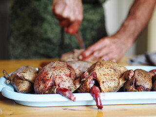 The process of butchering killed wild ducks.Trophy carcasses of ducks lie on a tray. Now they need to be washed.