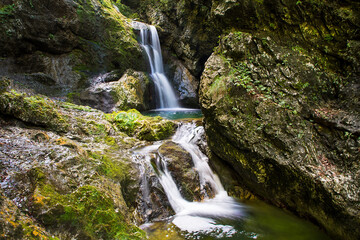 Fototapeta na wymiar Majestic waterfalls on the stream Gačnik, Soca valley, Slovenia, Europe