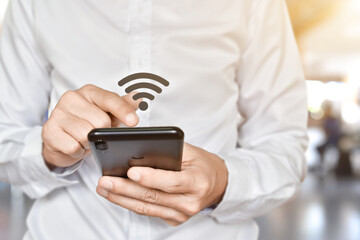 Man hand using mobile smartphone with wifi icon. Idea for business communication social network.