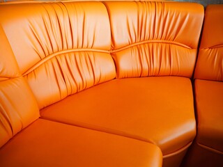 Curve of artificial leather sofa couch orange concept take a seat