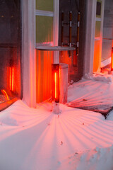 Infrared outdoor heaters in open air on streets of snow-covered city in winter, patio heaters