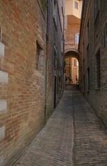 Fototapeta na wymiar typocal narrow street in old town of urbino, italy