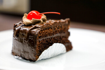 Chocolate cake with cherries and chocolate cream.