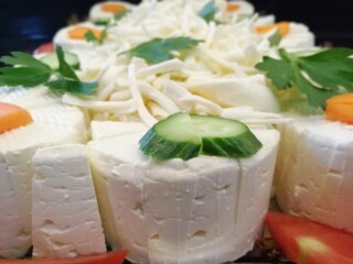 cheese plate served with various cheeses on the table