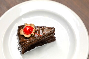 Chocolate cake with cherries and chocolate cream.