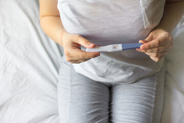 Woman holding pregnancy test, New life and new family concept.